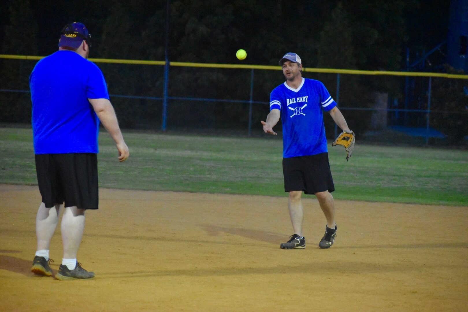 Softball Shortstop Brendon tosses the ball back to Hail Mary's pitcher Brent