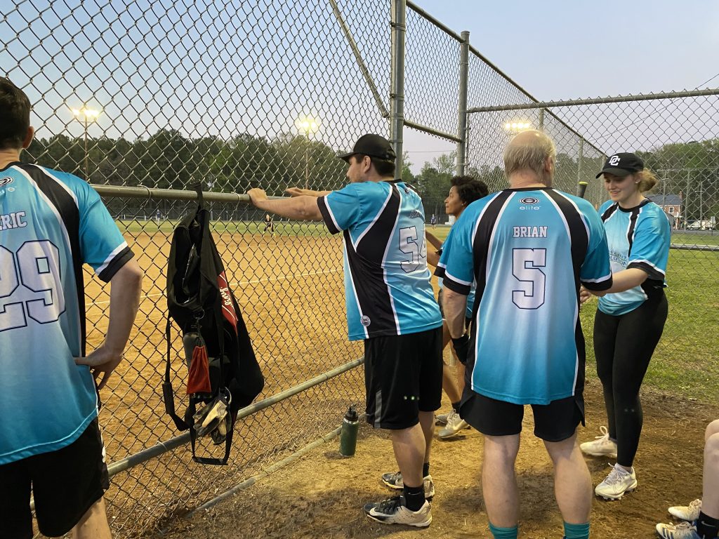 Eric and Juan watch the on field excitement as Brian and Faith discuss bats