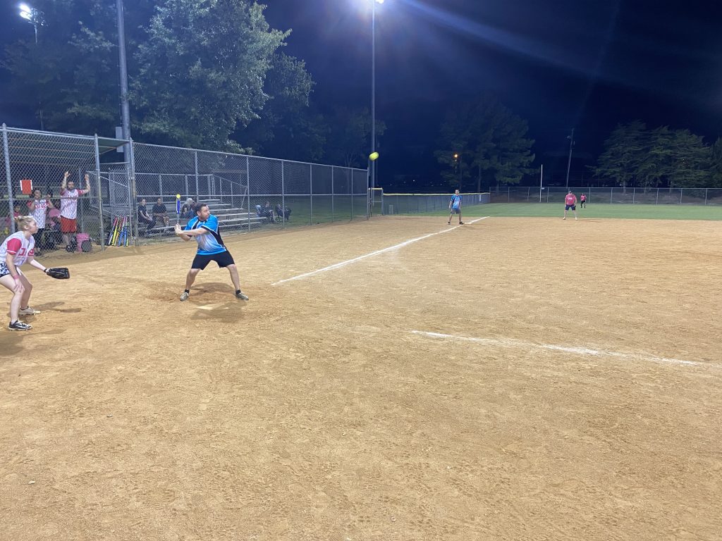 A group playing softball at night in Richmond, Virginia for RVA Softball Team Photos.