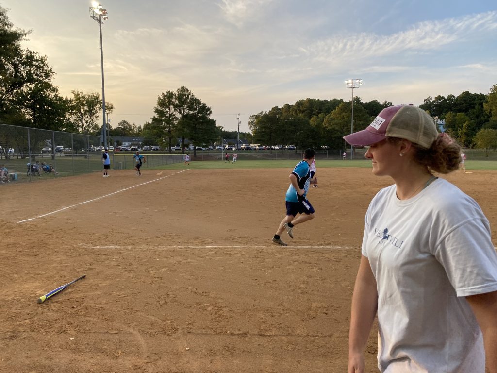 Faith looks on as Adam takes off toward first base.
