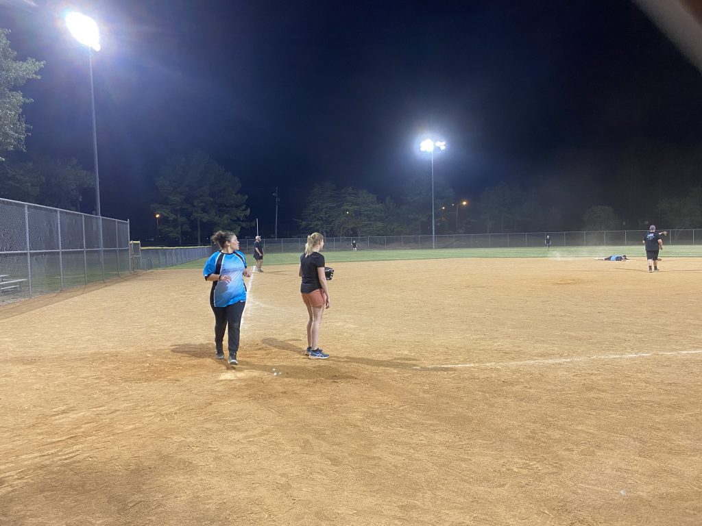 Anita scoring a run on a field in Richmond, Virginia at night.