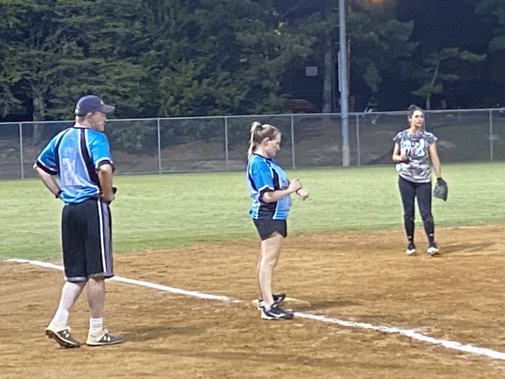 Lauren on third base, about to score.  Duke looks on, offering his coachly advice.