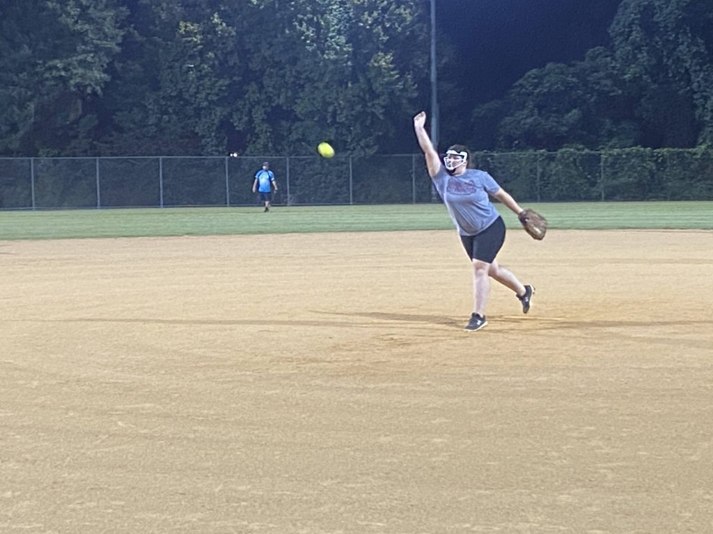 Colleen throwing a softball at night in Richmond, Virginia.